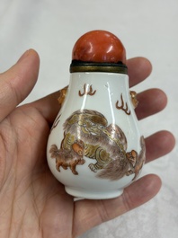 A Chinese gilt-decorated iron-red 'Buddhist Lions' snuff bottle with a red coral stopper, Buddhist Lion mark, Republic