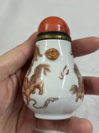 A Chinese gilt-decorated iron-red 'Buddhist Lions' snuff bottle with a red coral stopper, Buddhist Lion mark, Republic