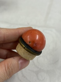 A Chinese gilt-decorated iron-red 'Buddhist Lions' snuff bottle with a red coral stopper, Buddhist Lion mark, Republic
