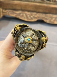 A Tibetan parcel-gilt silver and iron phurba inlaid with precious stones, red coral and bone, 19th C.