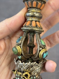 A Tibetan parcel-gilt silver and iron phurba inlaid with precious stones, red coral and bone, 19th C.