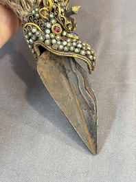 A Tibetan parcel-gilt silver and iron phurba inlaid with precious stones, red coral and bone, 19th C.