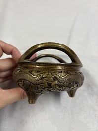 A Chinese bronze tripod 'Dragon' censer with two handles, Xuande mark, 19th C.