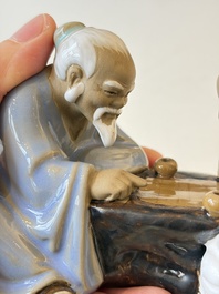 A Chinese polychrome-glazed Shiwan stoneware figure of Tudigong, a 'Shoulao' group and a 'Go Players' group, China marks, 19/20th C.