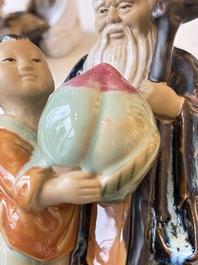 A Chinese polychrome-glazed Shiwan stoneware figure of Tudigong, a 'Shoulao' group and a 'Go Players' group, China marks, 19/20th C.