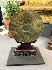 A pair of Chinese jade-inset wooden table screens, a jade-inset wooden ruyi with its original stand and a jade 'bi' disc on a wooden stand, 19/20th C.