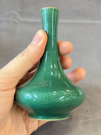 A Chinese green crackle-glazed vase on wooden stand and two famille rose 'Roosters' and 'Antiquities' water pots, 19th C.