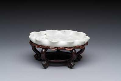 A Chinese Dehua blanc de Chine 'Lotus Leaf and Frog' brush washer on a wooden stand, Kangxi/Yongzheng