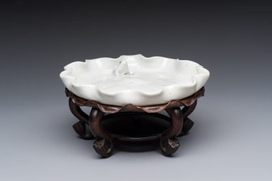 A Chinese Dehua blanc de Chine 'Lotus Leaf and Frog' brush washer on a wooden stand, Kangxi/Yongzheng