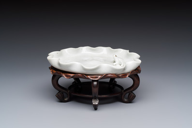 A Chinese Dehua blanc de Chine 'Lotus Leaf and Frog' brush washer on a wooden stand, Kangxi/Yongzheng