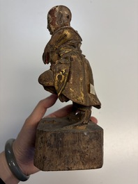 Eight Chinese carved wooden sculptures with traces of polychromy and gilding, 19th C.