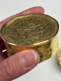 A fine Tibetan gilt-bronze box and cover with repouss&eacute; scroll decoration, 18th C.