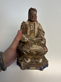 Eight Chinese carved wooden sculptures with traces of polychromy and gilding, 19th C.