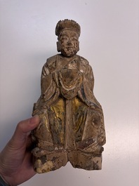 Eight Chinese carved wooden sculptures with traces of polychromy and gilding, 19th C.