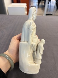 Two Chinese Dehua blanc de Chine groups of Guanyin and a vase with lion-head handles, 18th C. and later