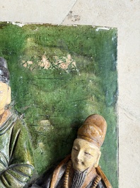 A large Chinese sancai-glazed architectural tile with two figures, Ming