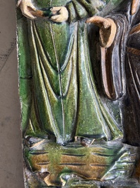 A large Chinese sancai-glazed architectural tile with two figures, Ming