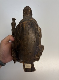 Eight Chinese carved wooden sculptures with traces of polychromy and gilding, 19th C.