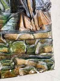 A large Chinese sancai-glazed architectural tile with two figures, Ming