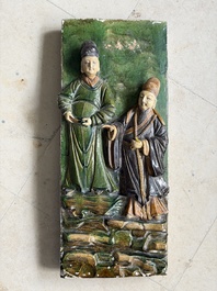 A large Chinese sancai-glazed architectural tile with two figures, Ming