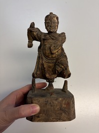 Eight Chinese carved wooden sculptures with traces of polychromy and gilding, 19th C.