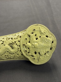 A large Chinese lemon-yellow-glazed biscuit 'Dragons' ruyi in the style of Wang Bingrong, on a wooden stand, Republic