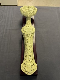 A large Chinese lemon-yellow-glazed biscuit 'Dragons' ruyi in the style of Wang Bingrong, on a wooden stand, Republic