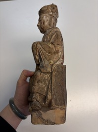 Eight Chinese carved wooden sculptures with traces of polychromy and gilding, 19th C.