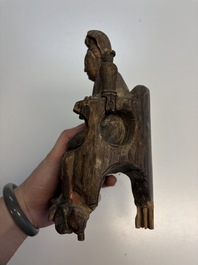 Eight Chinese carved wooden sculptures with traces of polychromy and gilding, 19th C.