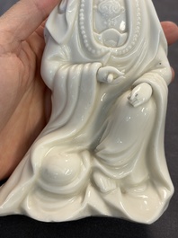Two Chinese Dehua blanc de Chine groups of Guanyin and a vase with lion-head handles, 18th C. and later