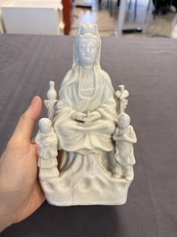 Two Chinese Dehua blanc de Chine groups of Guanyin and a vase with lion-head handles, 18th C. and later