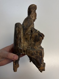 Eight Chinese carved wooden sculptures with traces of polychromy and gilding, 19th C.