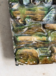 A large Chinese sancai-glazed architectural tile with two figures, Ming