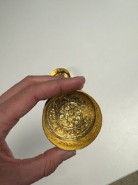 A fine Tibetan gilt-bronze box and cover with repouss&eacute; scroll decoration, 18th C.