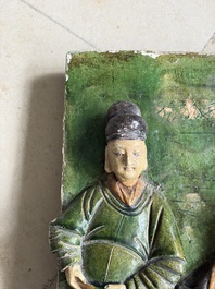 A large Chinese sancai-glazed architectural tile with two figures, Ming