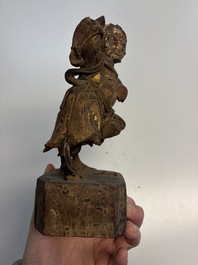 Eight Chinese carved wooden sculptures with traces of polychromy and gilding, 19th C.