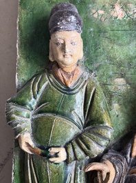 A large Chinese sancai-glazed architectural tile with two figures, Ming