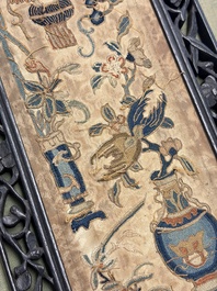 Two Chinese embroidered silk panels with antiquities and birds among flowering branches, 19th C.