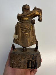 Eight Chinese carved wooden sculptures with traces of polychromy and gilding, 19th C.