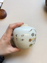 A Chinese blue and white covered jar and two polychrome-decorated jarlets with wooden covers, 18/19th C.