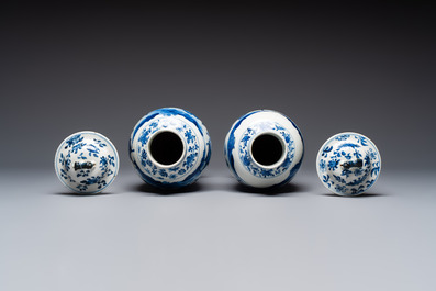 A pair of Chinese blue and white covered vases and two covered jars, Kangxi mark, 19th C