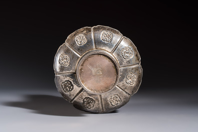 A Tibetan ritual jade bowl with a red coral-mounted silver cover and a stand, 19th C.
