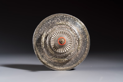 A Tibetan ritual jade bowl with a red coral-mounted silver cover and a stand, 19th C.