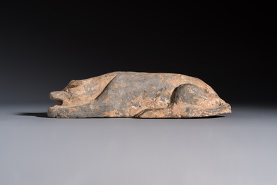 A Chinese grey pottery model of a reclining dog, Han