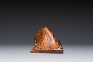 A Balinese carved wooden sculpture of a reclining lady, first half 20th C.