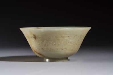 A Tibetan ritual jade bowl with a red coral-mounted silver cover and a stand, 19th C.
