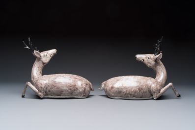 A pair of Chinese aubergine-glazed models of recumbent deer, 18/19th C.
