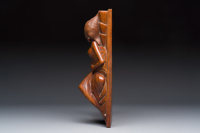 A Balinese carved wooden sculpture of a reclining lady, first half 20th C.