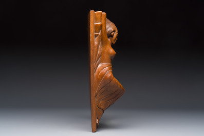 A Balinese carved wooden sculpture of a reclining lady, first half 20th C.