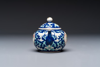 Three Chinese famille rose blue- and yellow-ground teapots and covers for the Straits or Peranakan market, Tongzhi marks, 19th C.